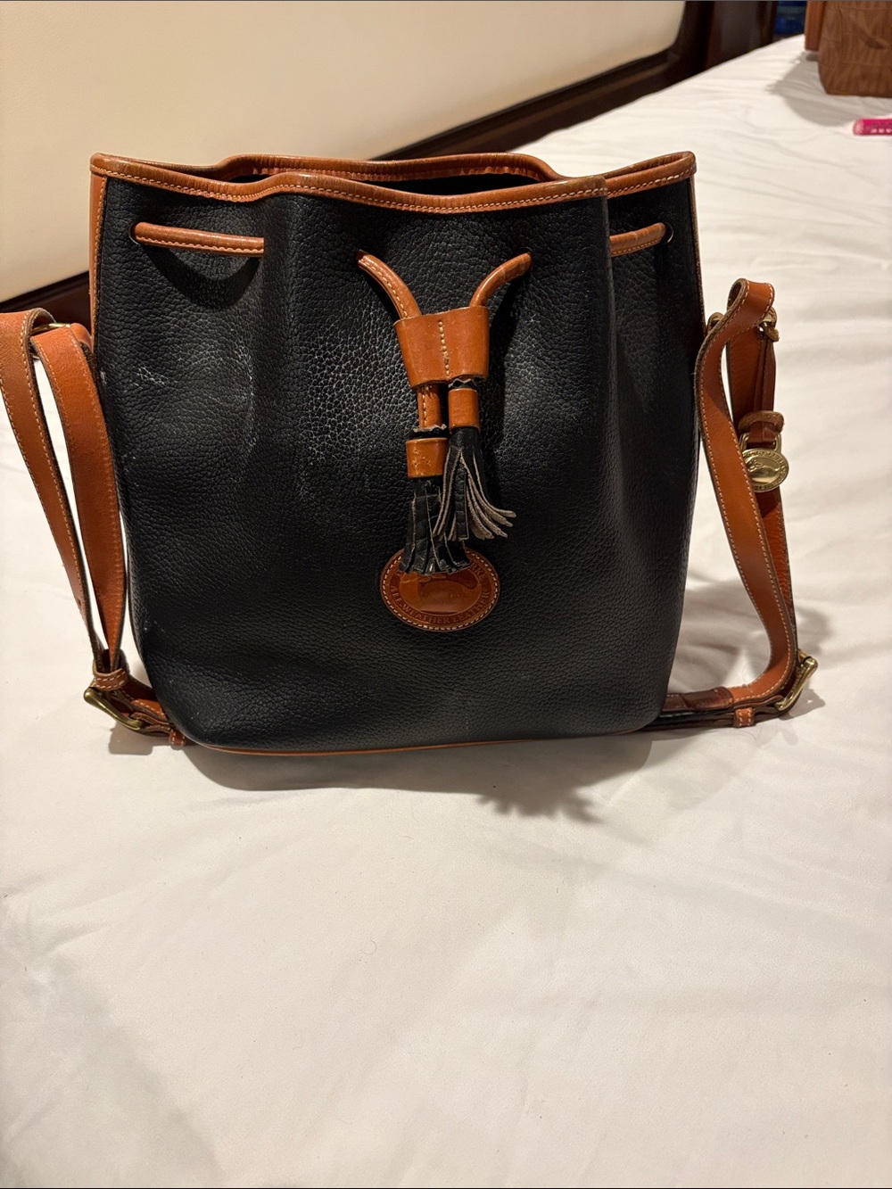 Dooney & Bourke Black Pebbled Leather Bucket Crossbody with Tan Trim